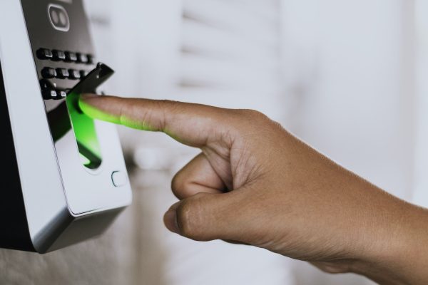 Scanning finger on a coronavirus contaminated fingerprint access control