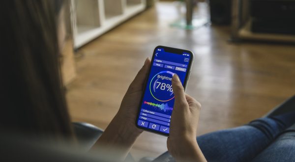 young-woman-with-smartphone-with-smart-home-control-functions.jpg